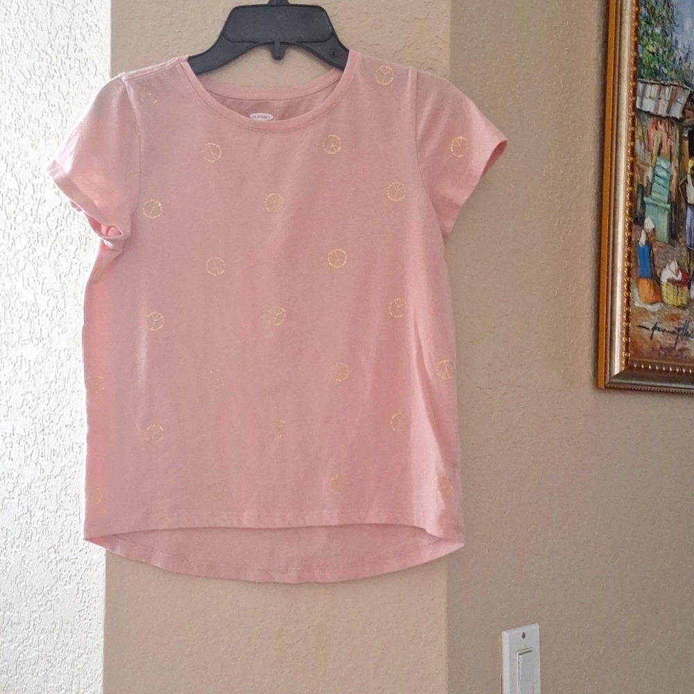 A pink shirt with peace signs on it